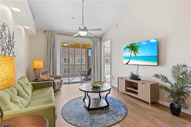 a living room with furniture a chandelier and a table
