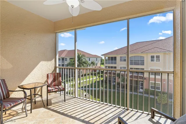 a view of a balcony with two chairs and wooden floor