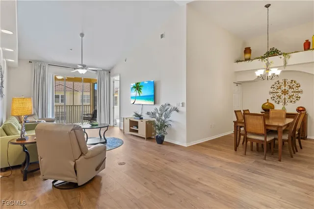 a dining room with furniture a chandelier and wooden floor