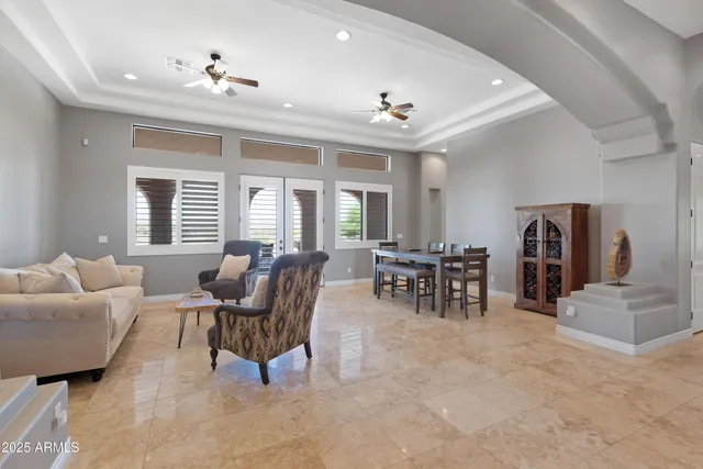 a spacious bathroom with a granite countertop sink a mirror and a shower