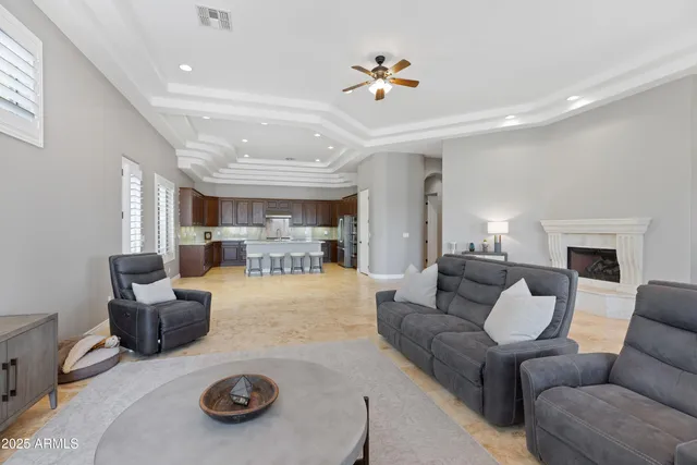 a living room with furniture and a chandelier