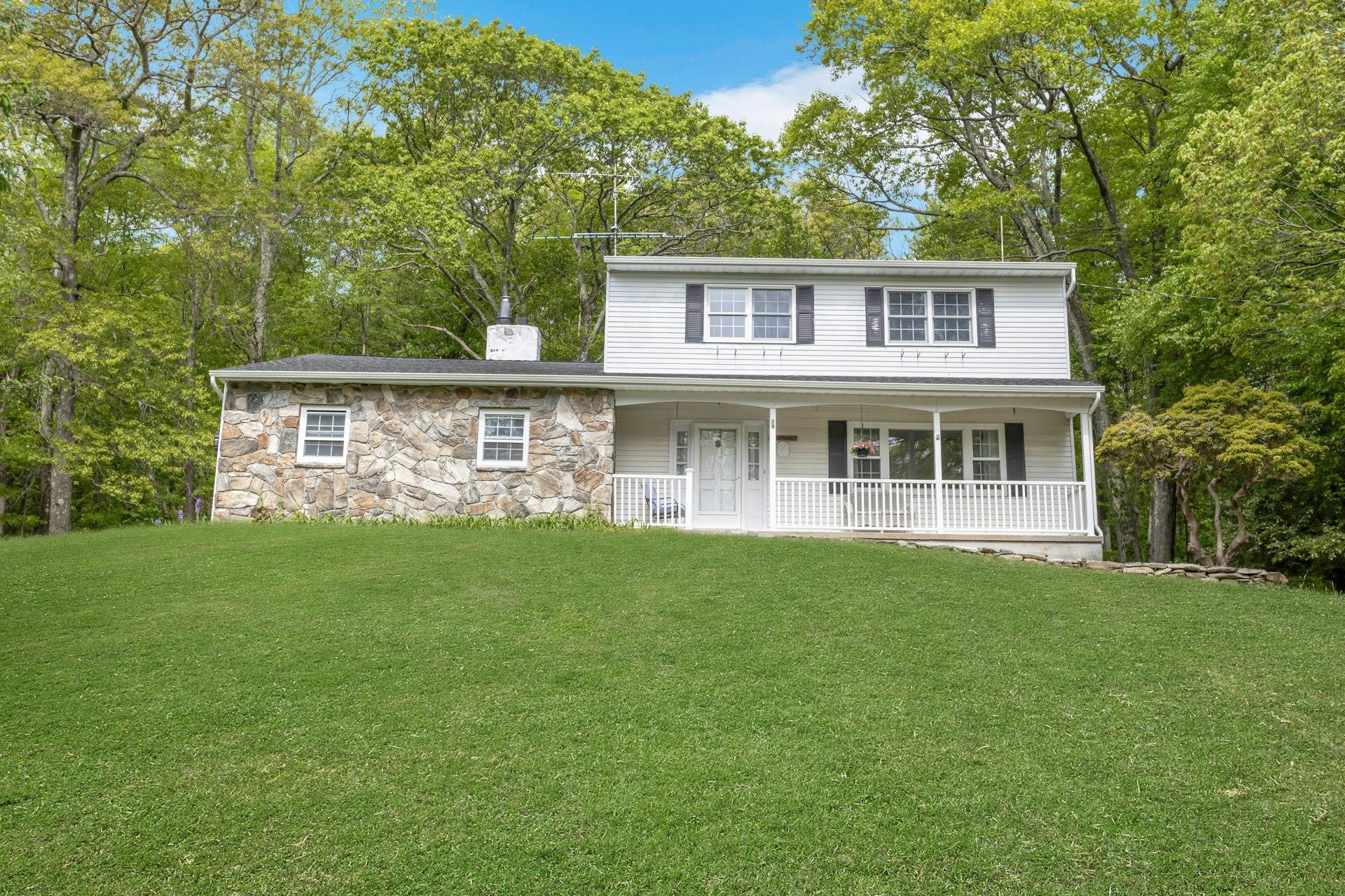 28 Mey Crescent Road Stormville, NY 12582 - Photo 1 of 1 Front view home with a chimney, a porch, a front yard, and stone siding