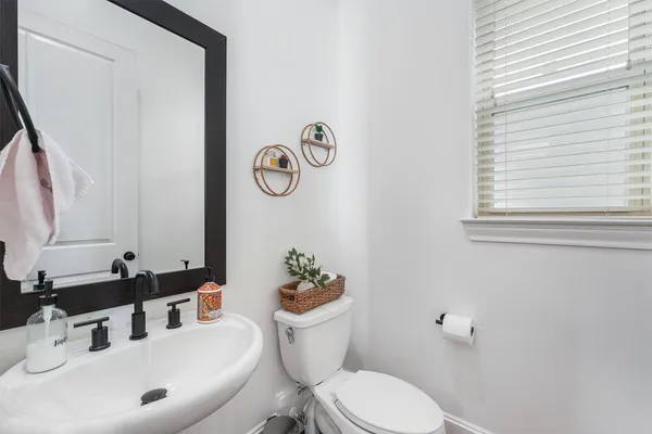 a bathroom with a sink mirror vanity and toilet