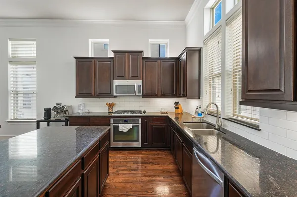 a kitchen with a sink stove top oven and microwave