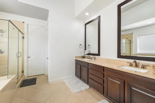 a spacious bathroom with a tub shower and a sink