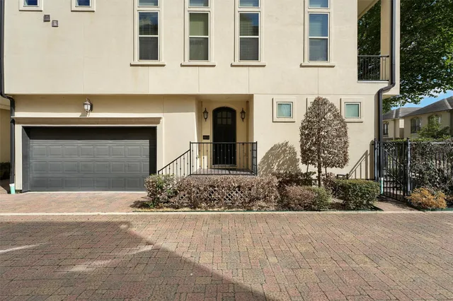a front view of a house with lots of garage and plants