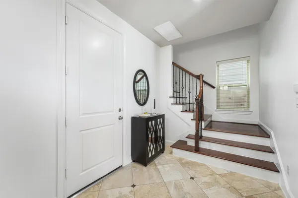 a view of a hallway with entryway wooden floor and front door