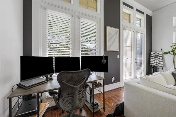 a view of a workspace with furniture and a window