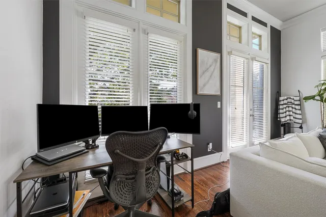a view of a workspace with furniture and a window