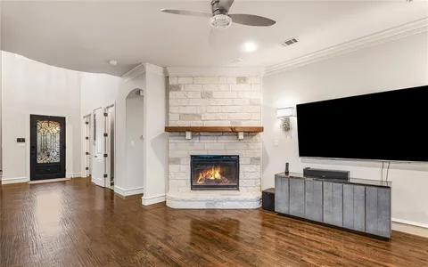 a living room with furniture fireplace and flat screen tv
