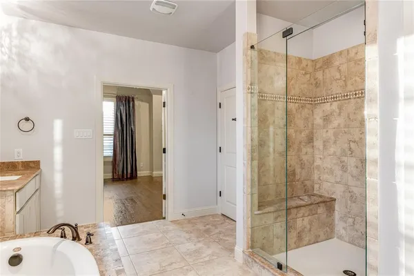 a bathroom with a shower and a sink