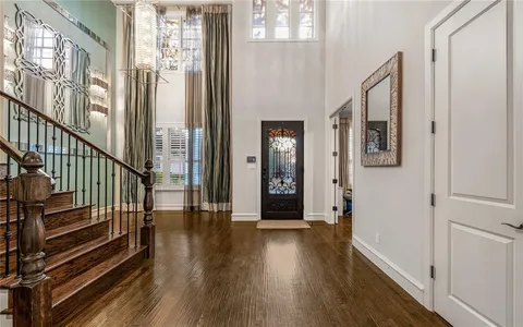 a view of an entryway with wooden floor and stairs