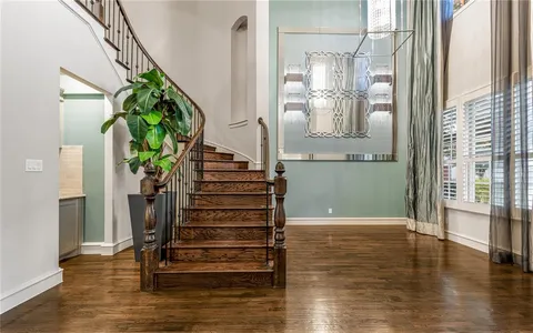 a view of entryway and hall with wooden floor