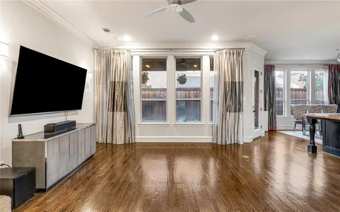 a view of a livingroom with wooden floor and furniture