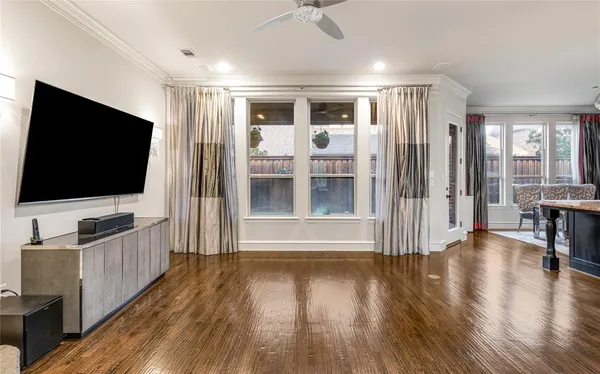 a view of a livingroom with wooden floor and furniture