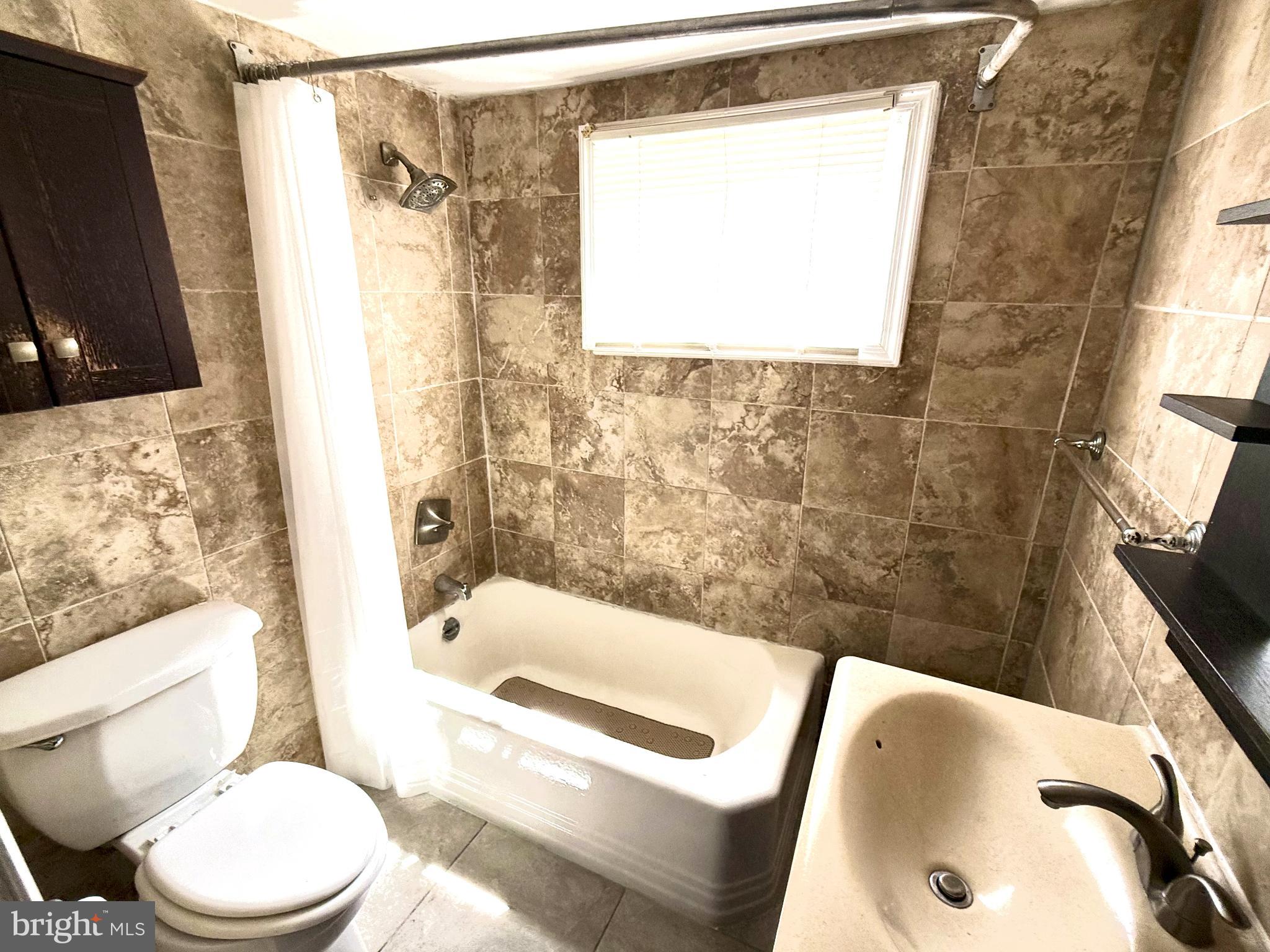 706 Dudley Street Philadelphia, PA 19148 - Photo 6 of 8 a bathroom with a sink toilet and shower