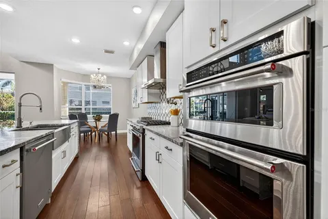 a stove top oven sitting inside of a kitchen