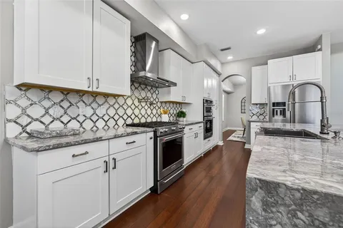 a kitchen with stainless steel appliances a sink stove and refrigerator