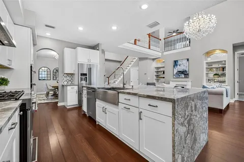 a living room with furniture a table and a large window