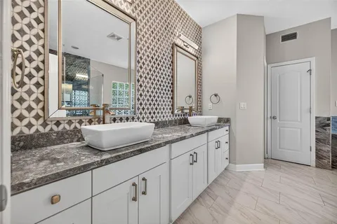 a bath tub sitting in a bathroom next to a window