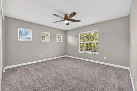 a view of empty room with a ceiling fan