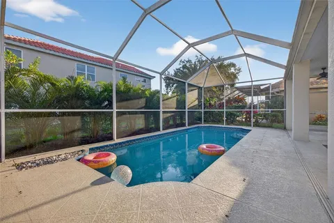 an aerial view of residential house with outdoor space and swimming pool