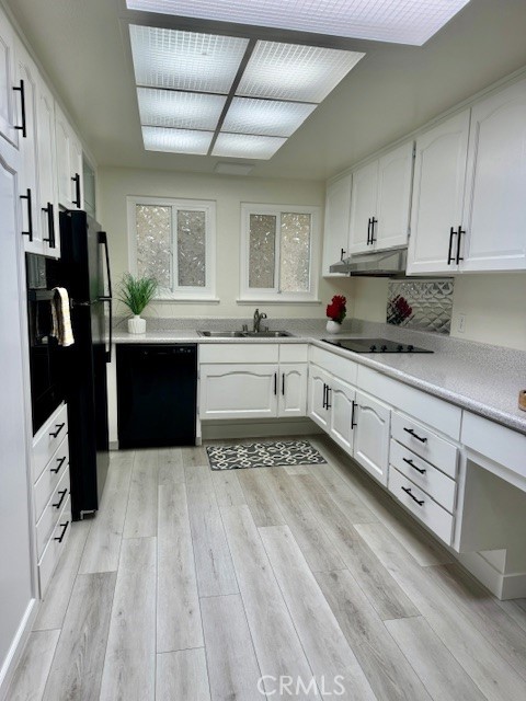 a kitchen with stainless steel appliances granite countertop a sink stove refrigerator and cabinets