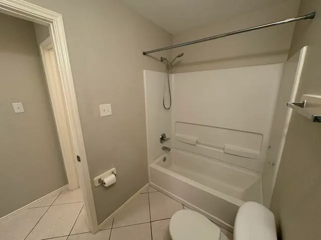 a bathroom with a granite countertop shower a toilet and a sink