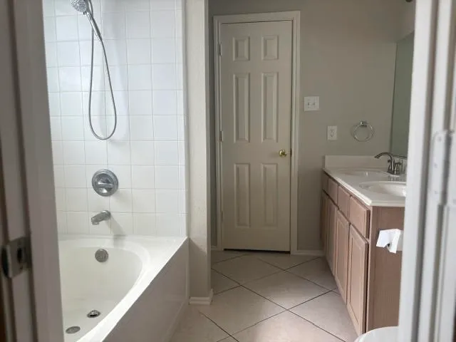 a bathroom with a tub sink and mirror