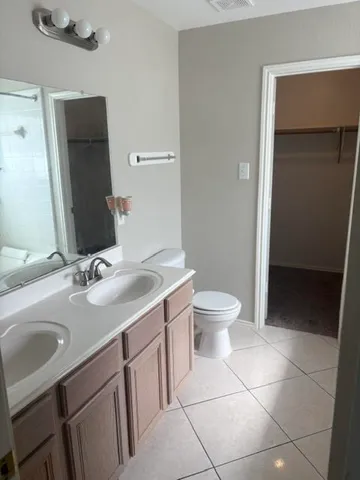 a bathroom with a sink toilet and mirror