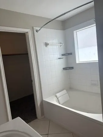 a bathroom with a bathtub and a shower