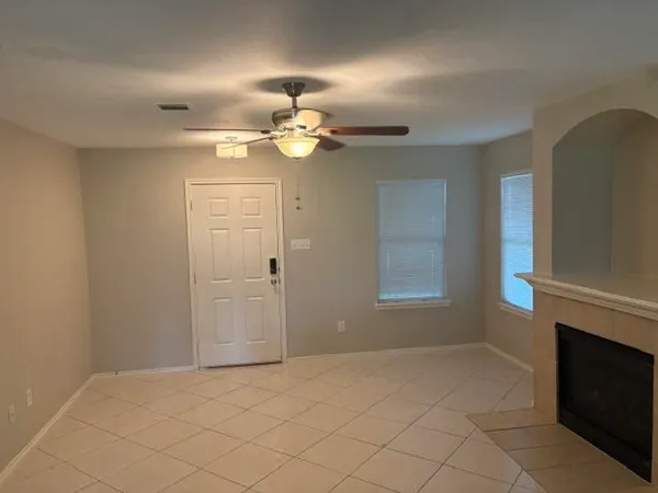 a view of an empty room with a fireplace