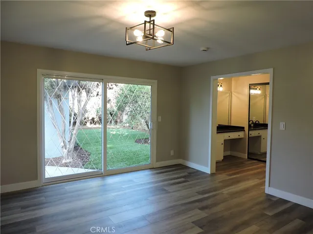 a view of a room with wooden floor staircase and windows