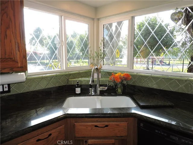 a kitchen with a sink and large window
