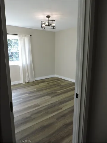 a view of room with window and hardwood floor