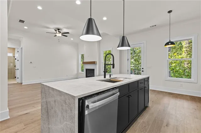 a kitchen with a table a sink and wooden floor