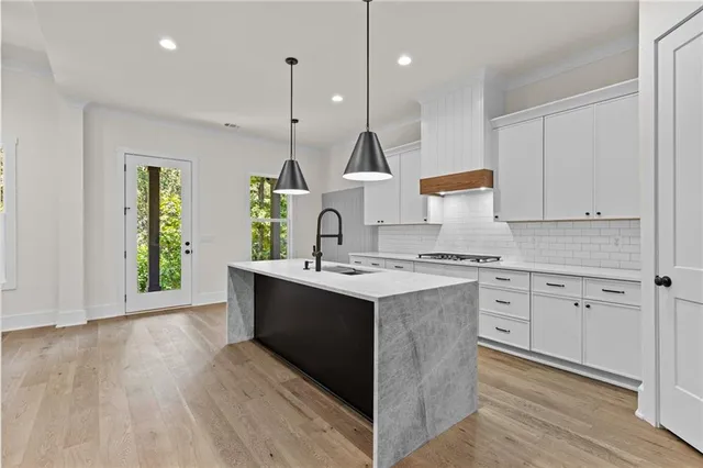 a kitchen with a sink stove and cabinets