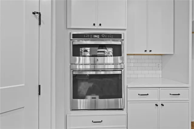a stove top oven sitting inside of a kitchen