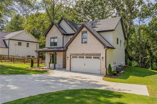 a view of a house with a yard and fence