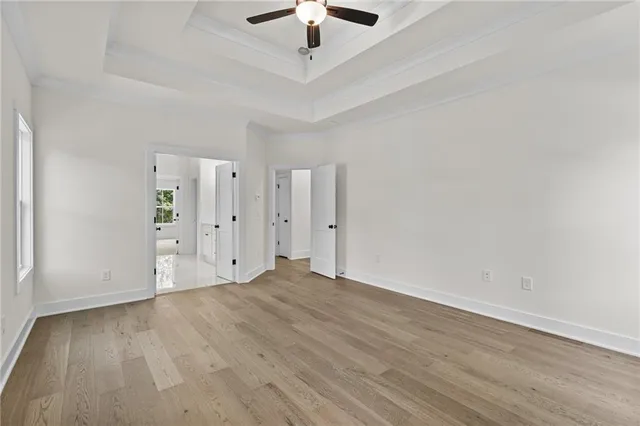 wooden floor in an empty room with a ceiling fan