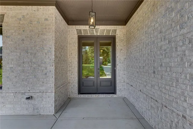a hallway with a chandelier fan and fire place