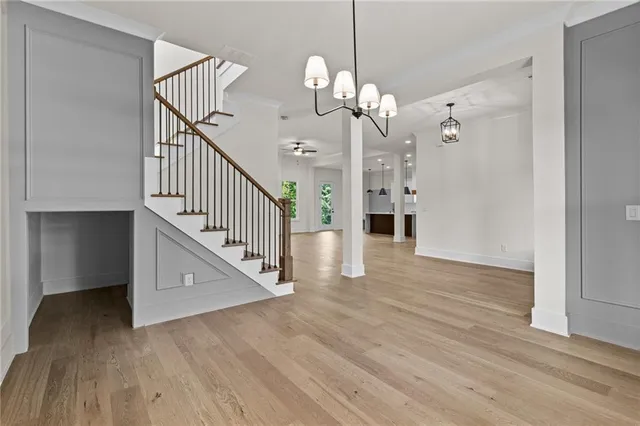 a view of a hallway with wooden floor and staircase