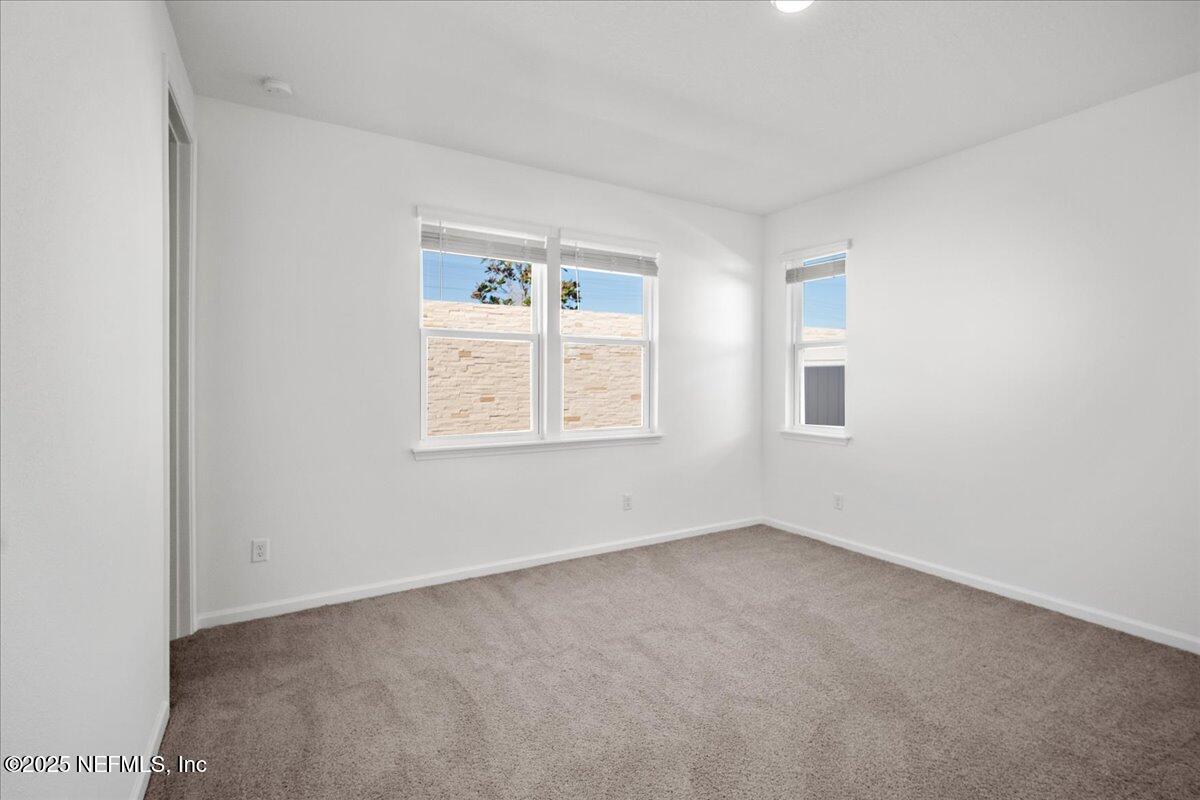 7212 Red Timber Road Jacksonville, FL 32244 - Photo 13 of 31 an empty room with windows