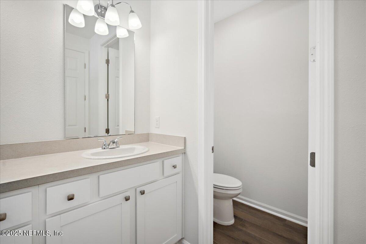 7212 Red Timber Road Jacksonville, FL 32244 - Photo 17 of 31 a bathroom with a granite countertop sink a toilet and a mirror