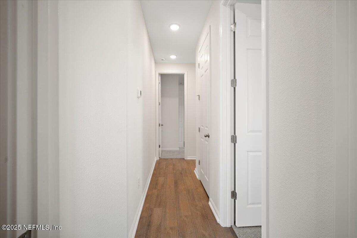 7212 Red Timber Road Jacksonville, FL 32244 - Photo 19 of 31 a view of a hallway with wooden floor and closet