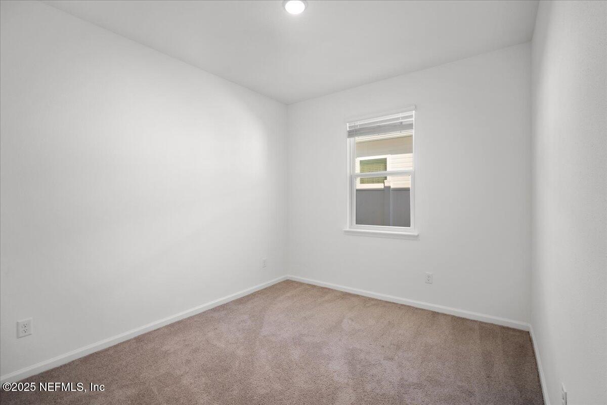 7212 Red Timber Road Jacksonville, FL 32244 - Photo 22 of 31 an empty room with a window