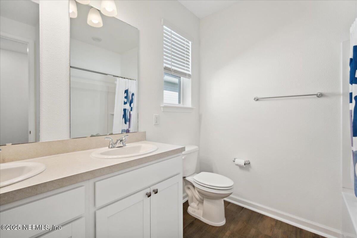 7212 Red Timber Road Jacksonville, FL 32244 - Photo 24 of 31 a bathroom with a toilet sink and mirror