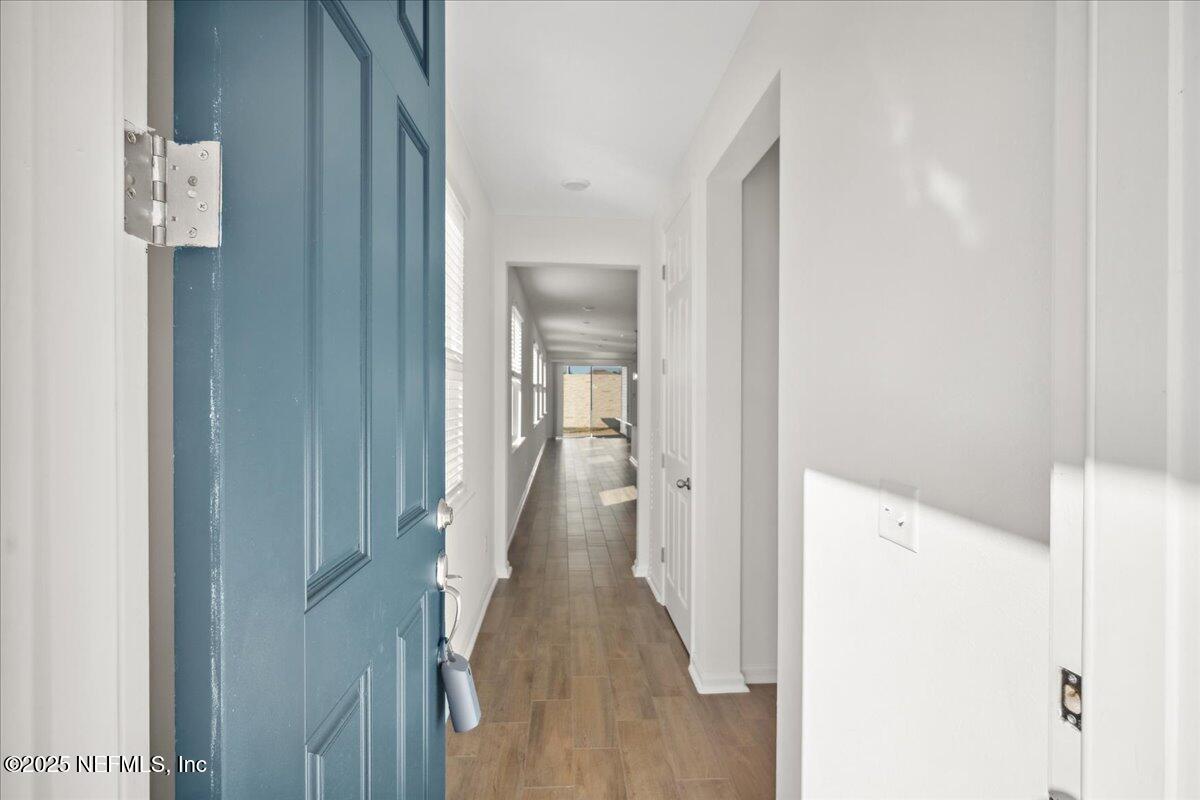 7212 Red Timber Road Jacksonville, FL 32244 - Photo 5 of 31 a view of a hallway with a wooden floor