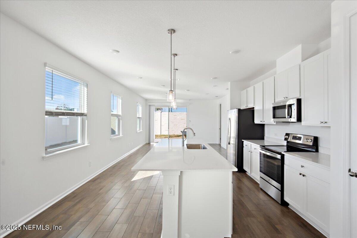 7212 Red Timber Road Jacksonville, FL 32244 - Photo 9 of 31 a large kitchen with granite countertop a large counter top appliances and cabinets
