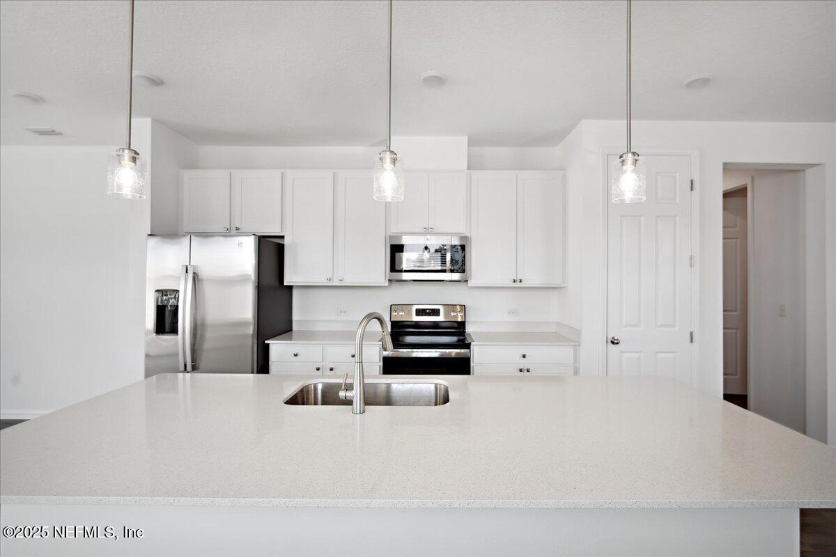 7212 Red Timber Road Jacksonville, FL 32244 - Photo 10 of 31 a kitchen with stainless steel appliances a refrigerator sink and stove